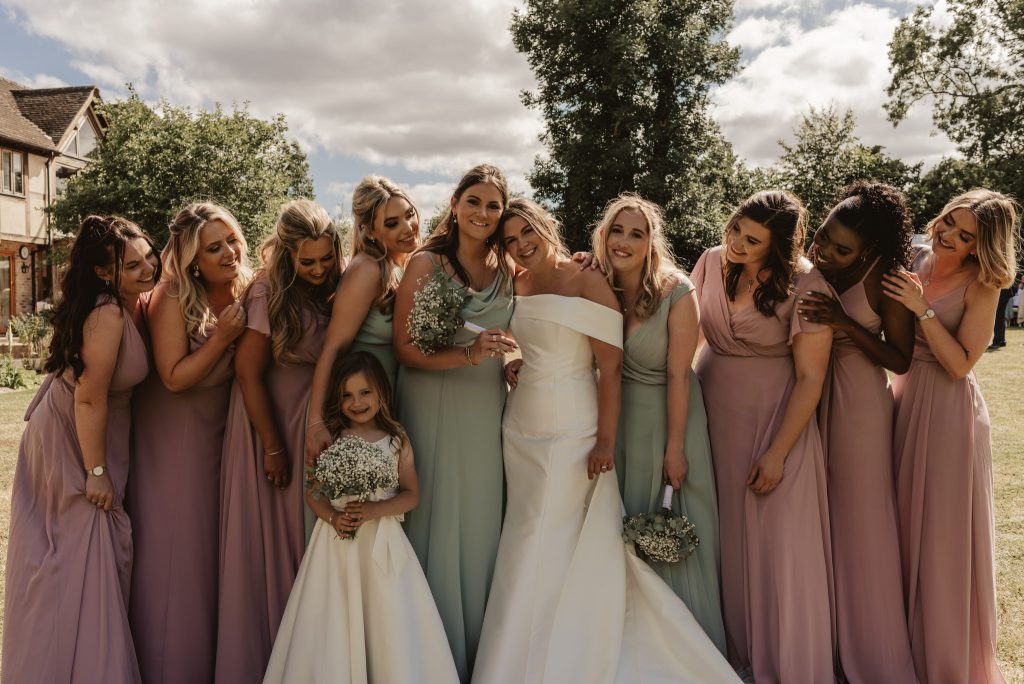 bride with bridesmaids and flower girl in white, green and pink colours