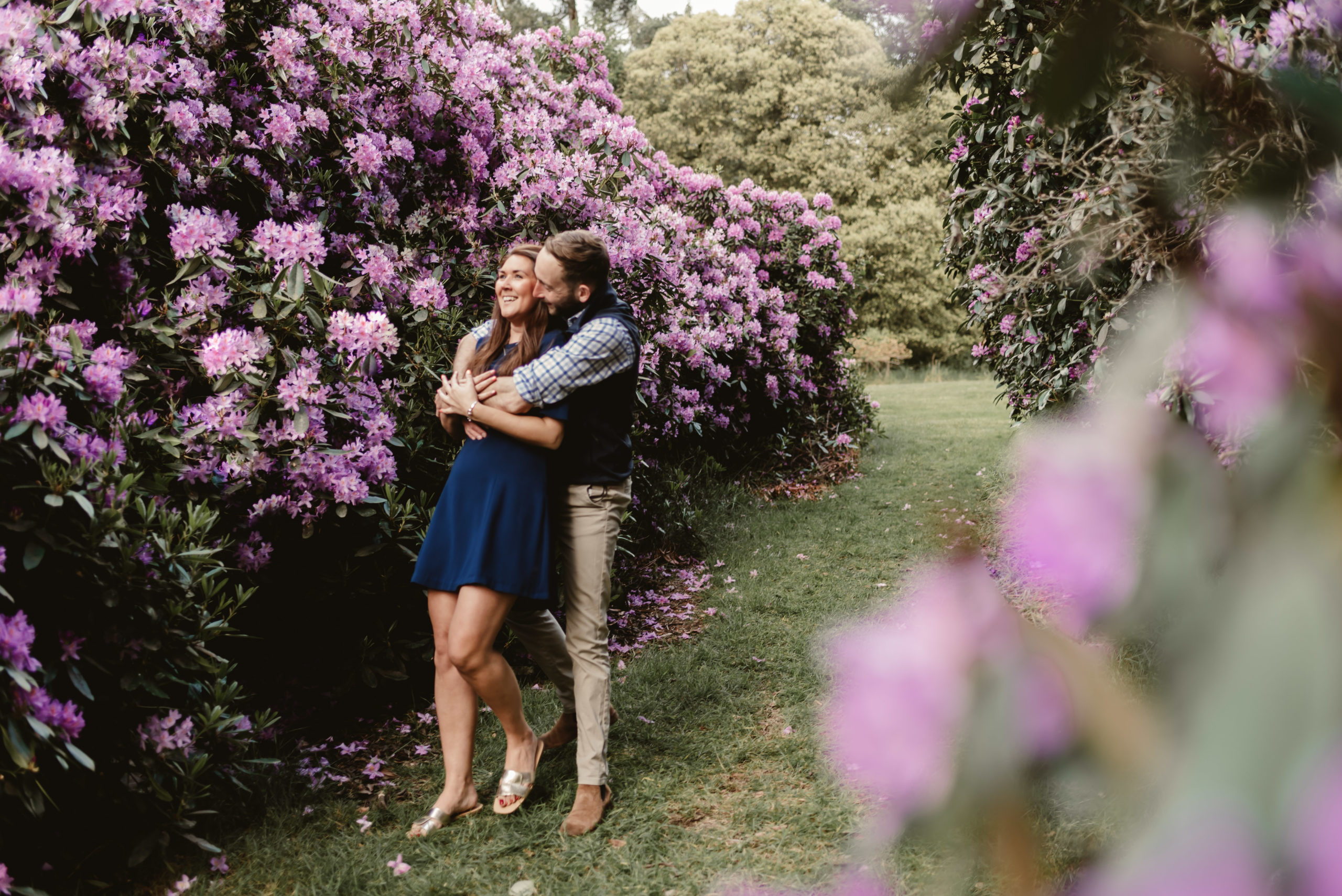 couple bear hug in the purple flowers