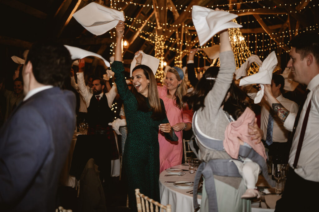 guests waving napkins and cheering