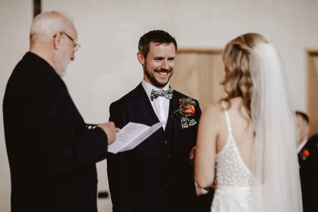 groom smiling at bride during the wedding ceremony 