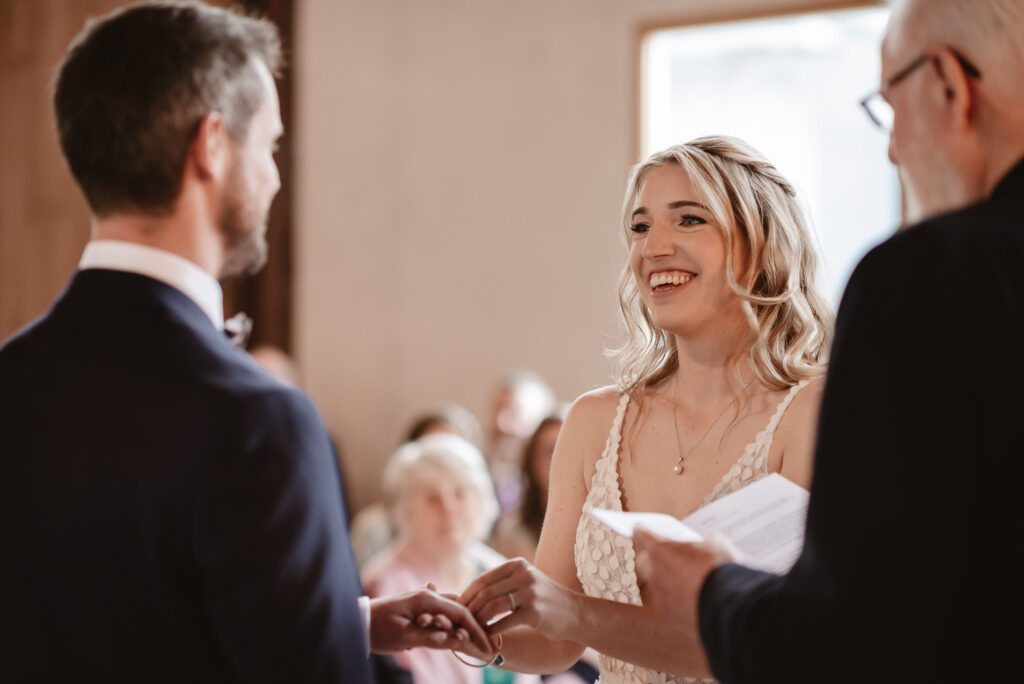 bride smiling at the groom in exchanging of the wedding rings