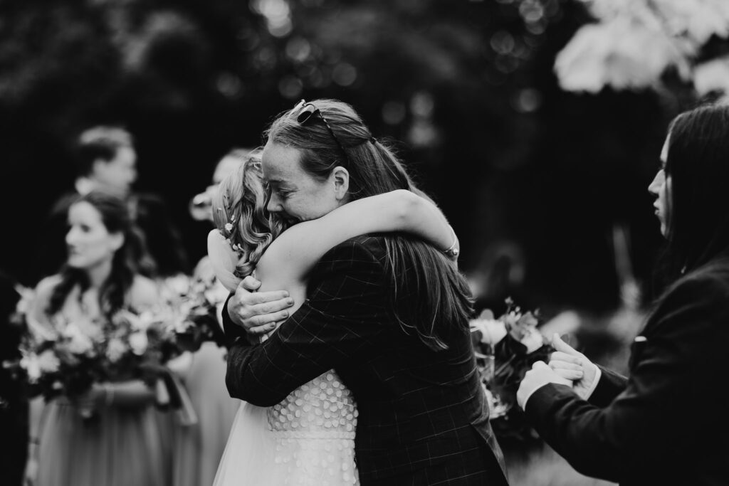 black and white image of bride holding a guest