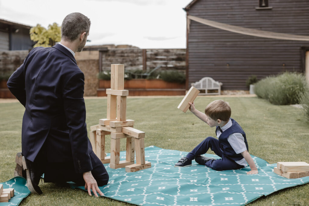 father and son playing with games outside on the picnic table 