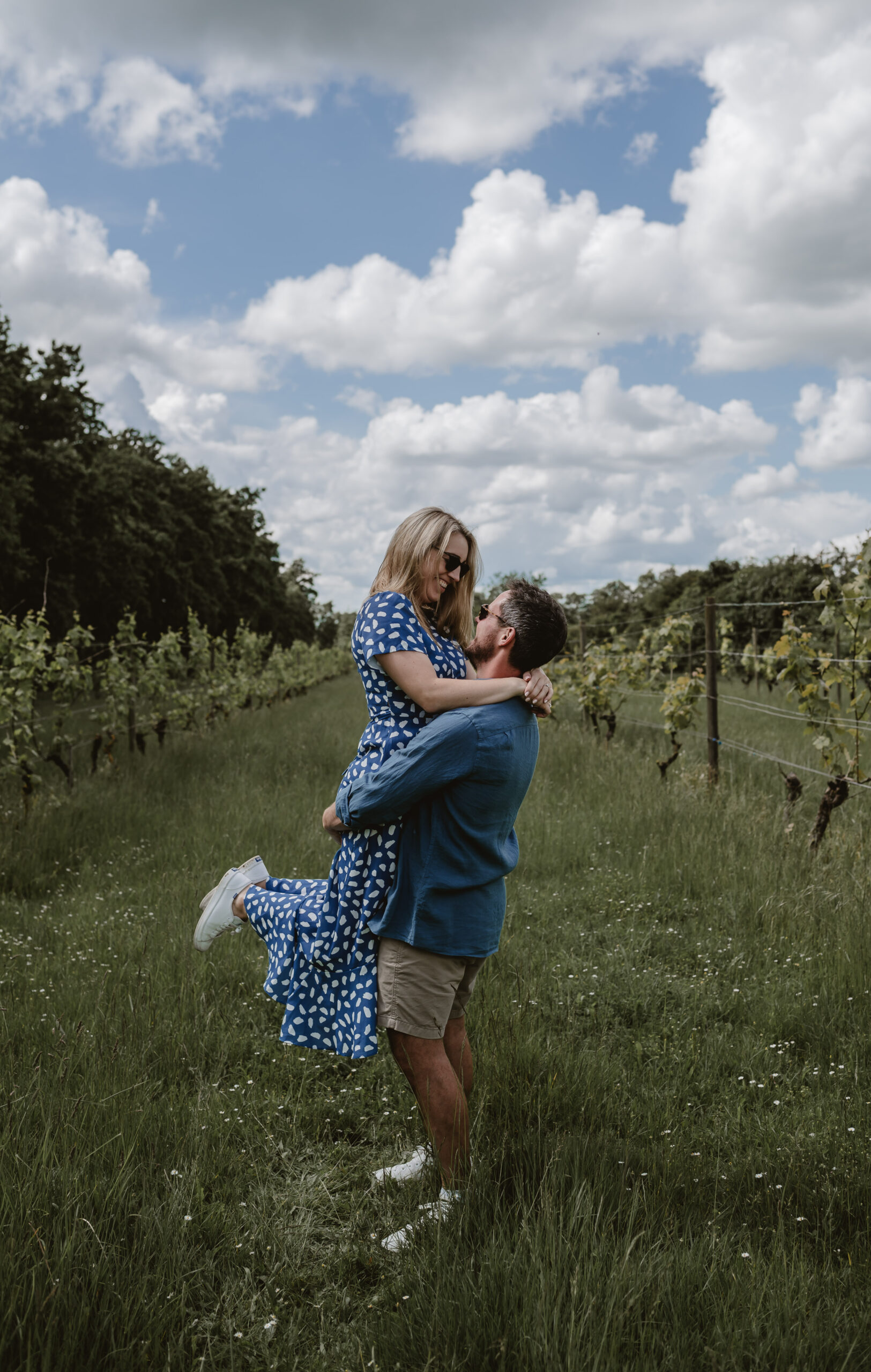 Couple dancing in a vineyard in the sunshine