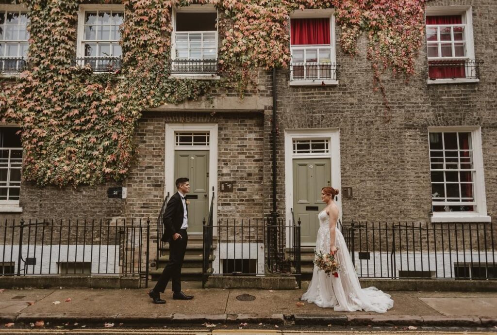 bride and groom walking towards each other in the middle of Cambridge city